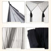 Elegant black lace canopy mosquito net draped over a bed frame.