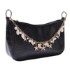 Black faux leather shoulder bag with a gold chain featuring starfish and pearl charms