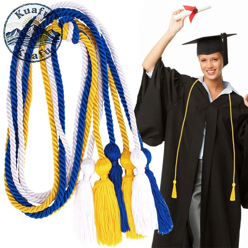 A bundle of graduation honor cords in blue, white, and yellow with tassels shown next to a black graduation gown.