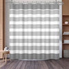 A shower curtain featuring horizontal geometric stripes in shades of gray and white.