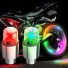 Motion-activated LED tire valve lights mounted on a motorcycle wheel.