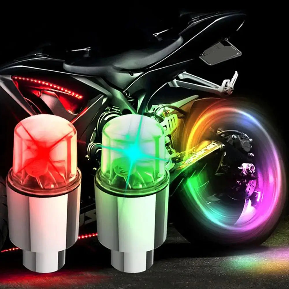 Motion-activated LED tire valve lights mounted on a motorcycle wheel.