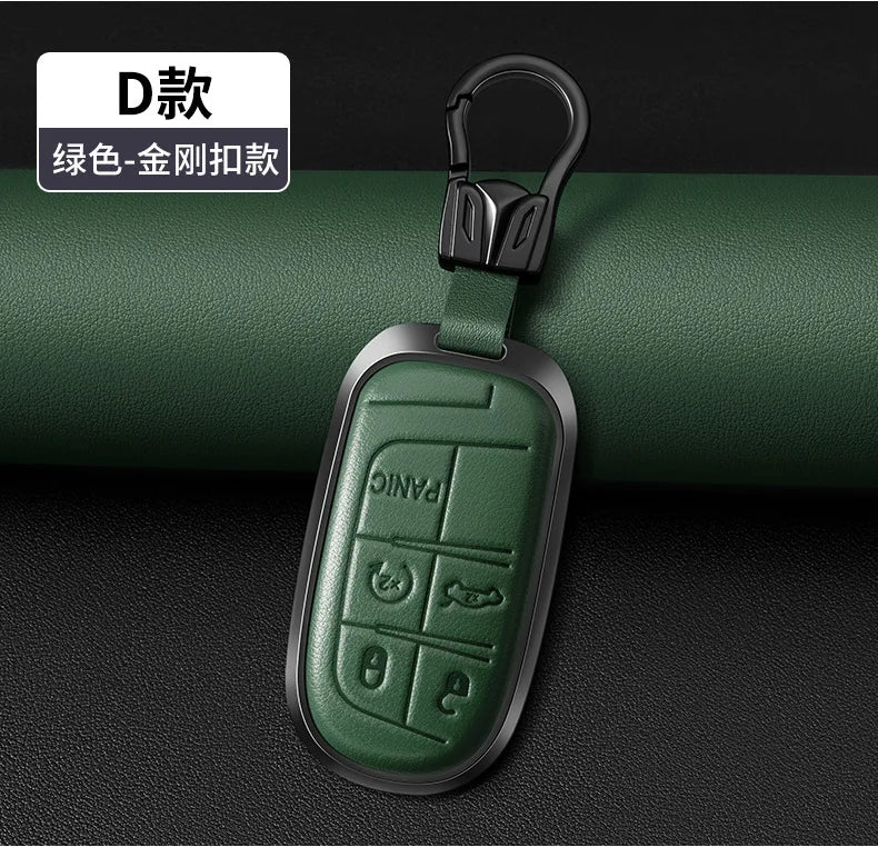 A dark green leather and metal key fob with a split ring attached, shown against a black background.