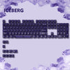 A close-up view of a purple and white mechanical keyboard keycap set with an iceberg theme.