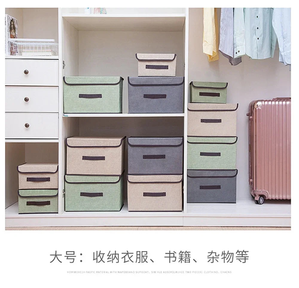 A set of fabric storage boxes in various shades of green, gray, and beige displayed on a white shelf.