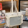A cream-colored Y2K Lolita transparent shoulder bag with lace trim displayed in a retail setting.