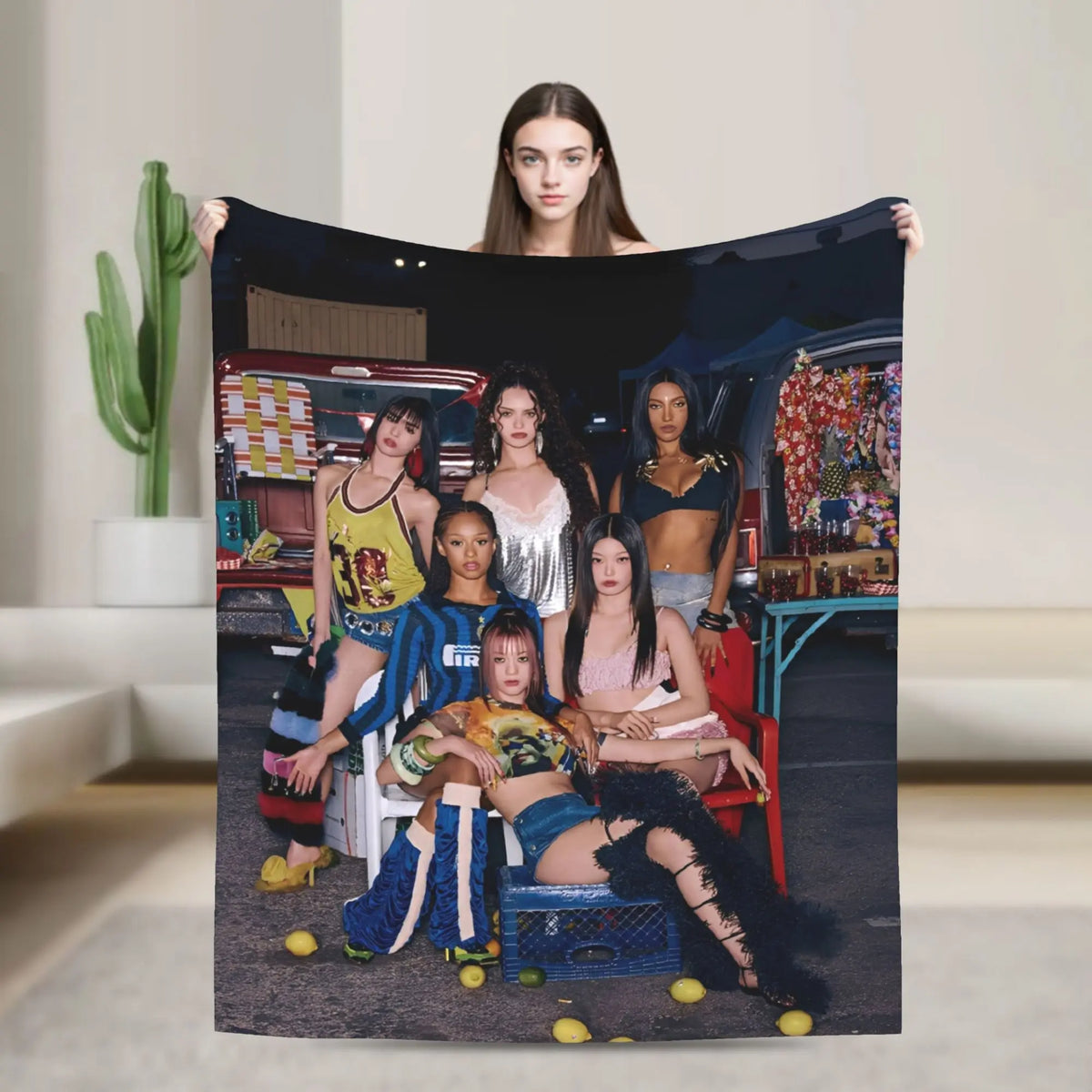 A large print featuring a woman holding a black fabric with colorful imagery and other women in various outfits.