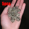 Five glow-in-the-dark acrylic dice set held in a hand for night games