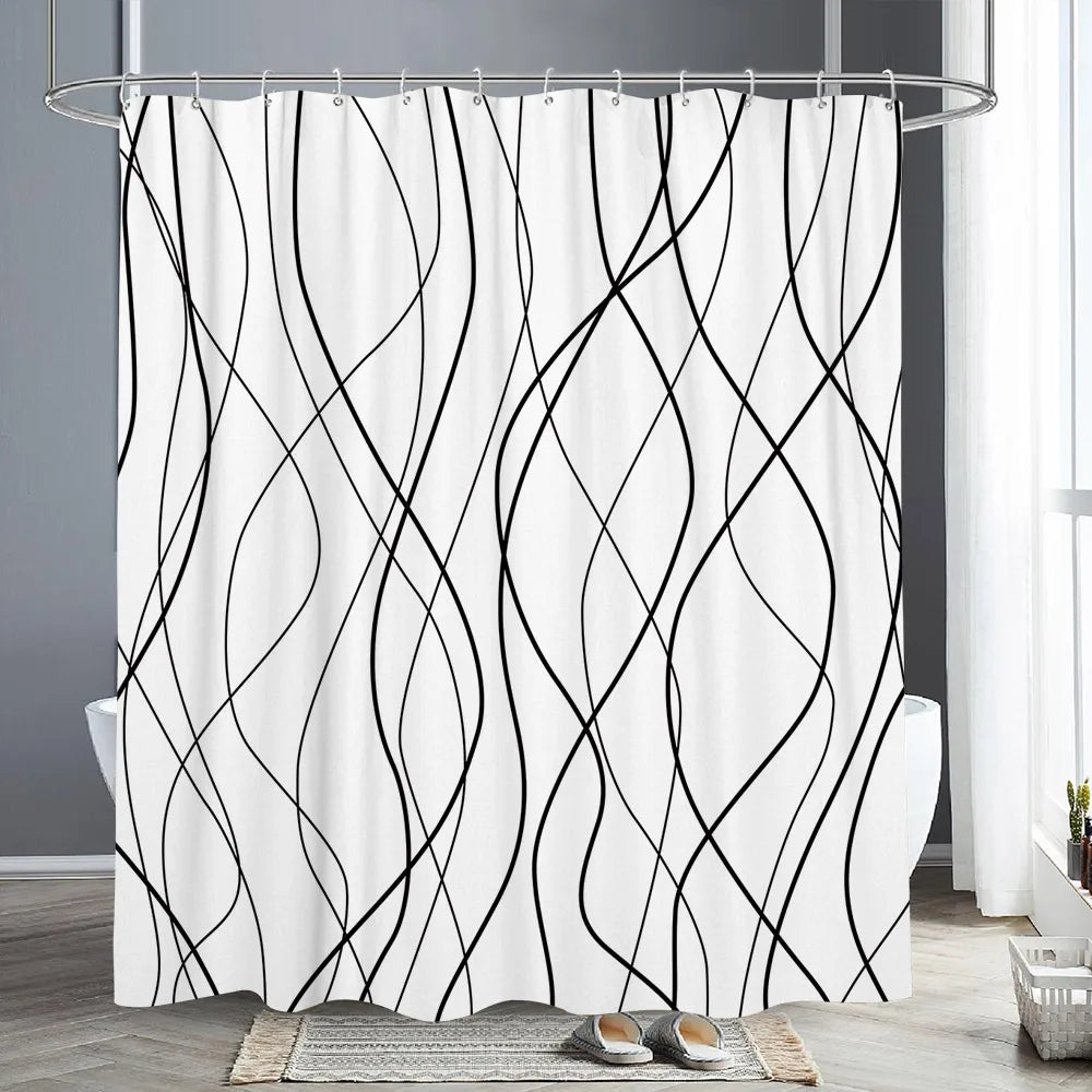 A white shower curtain featuring abstract black, flowing geometric lines against a white background.