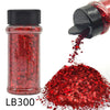 A glass jar of red glitter and a black shaker top with loose red glitter spilled below