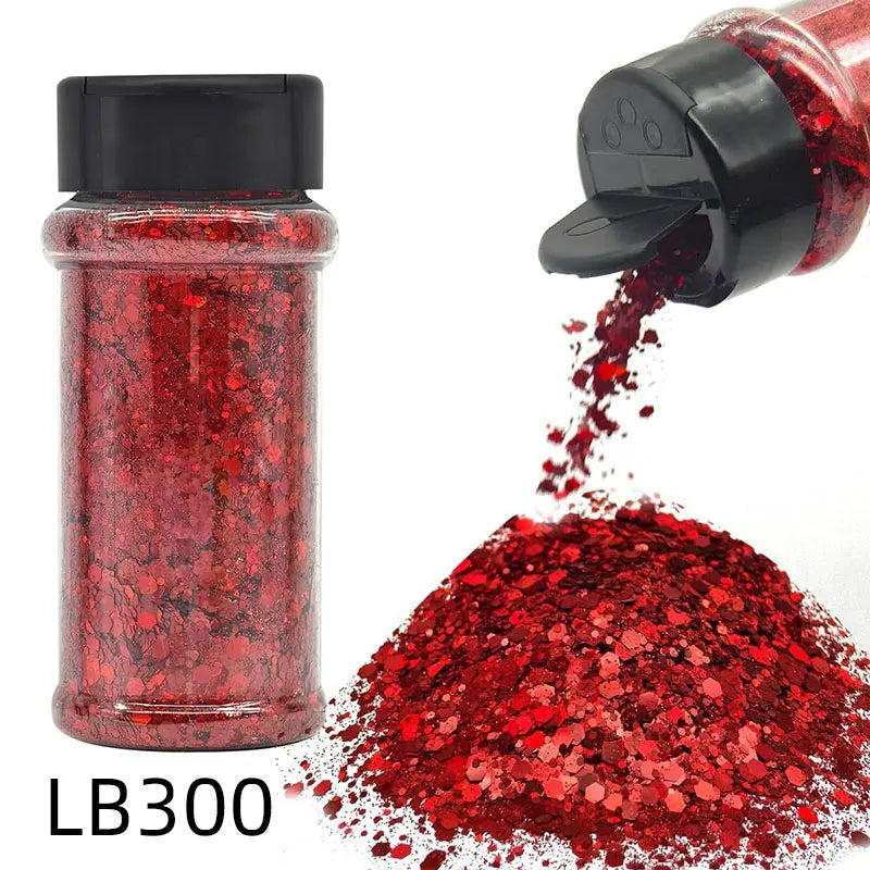 A glass jar of red glitter and a black shaker top with loose red glitter spilled below