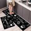 Black non-slip kitchen rug featuring a white espresso coffee design on a light wood floor.
