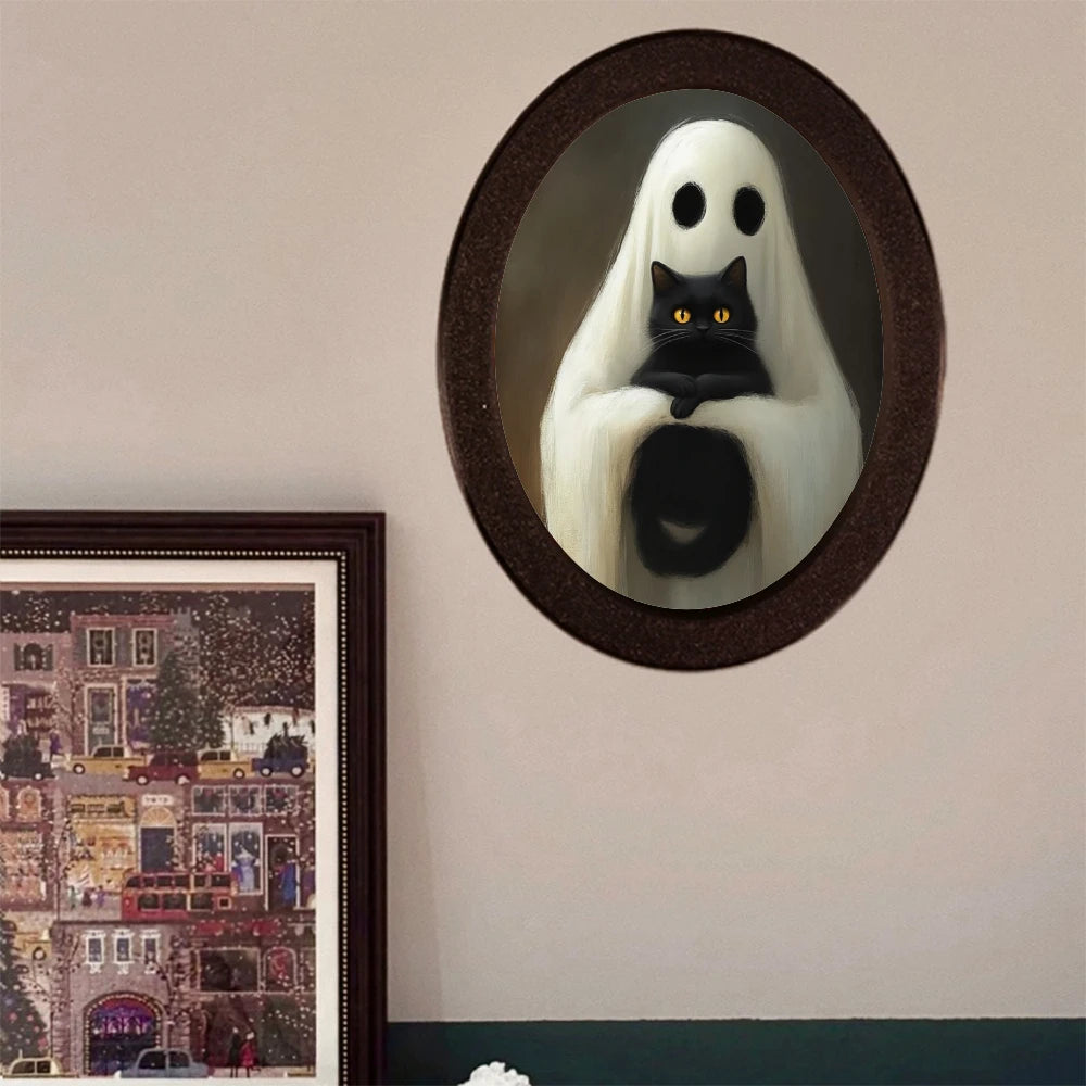 An oval decorative ornament featuring a ghost figure with white drapery and a black cat sitting on its body.