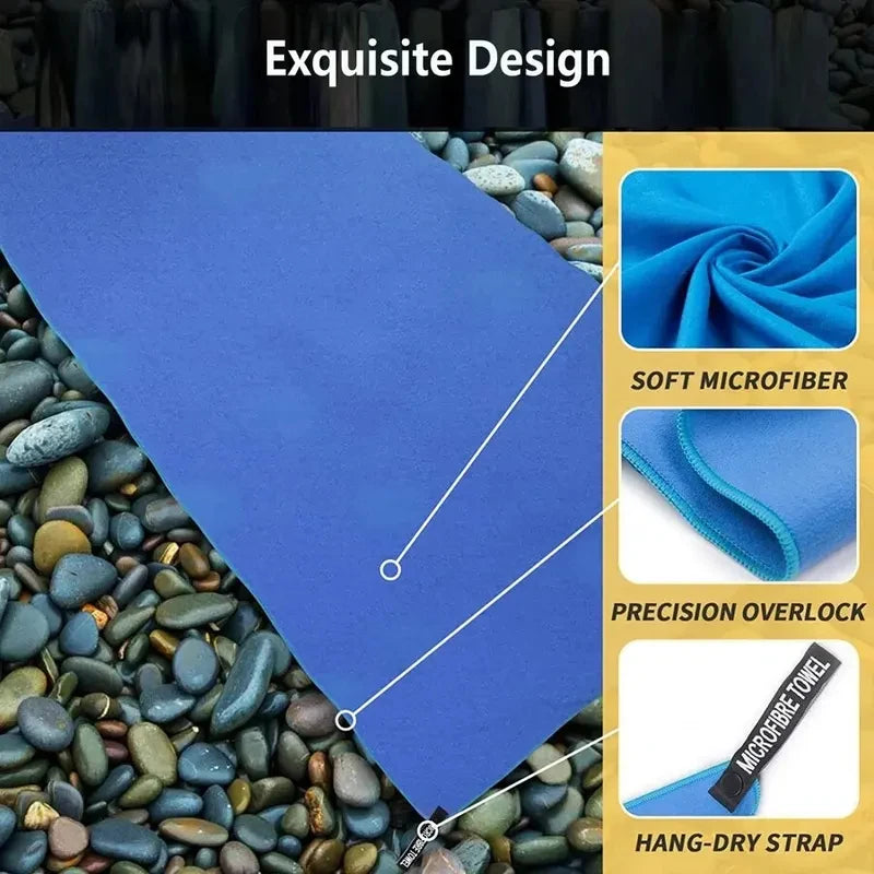 A purple microfiber sports towel with a precision overlock and hang-dry strap shown next to small stones.