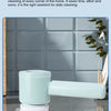 A light blue cordless electric spin scrubber with a white brush head cleaning a dark countertop.