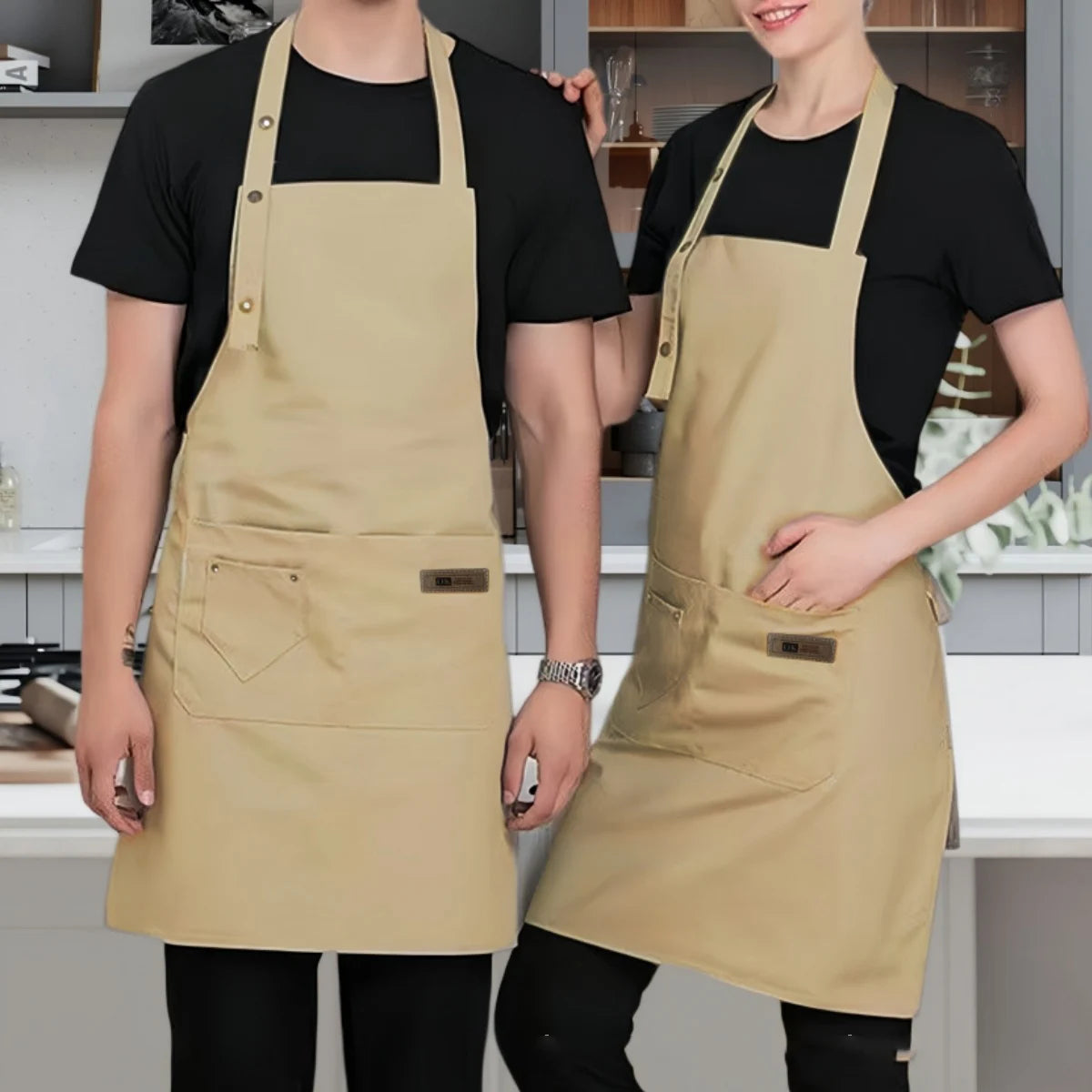 A woman models a beige canvas kitchen apron with pockets and a collar against a light gray background.