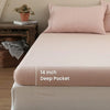 A pink linen fitted sheet with a 14 inch deep pocket is displayed on a bed.