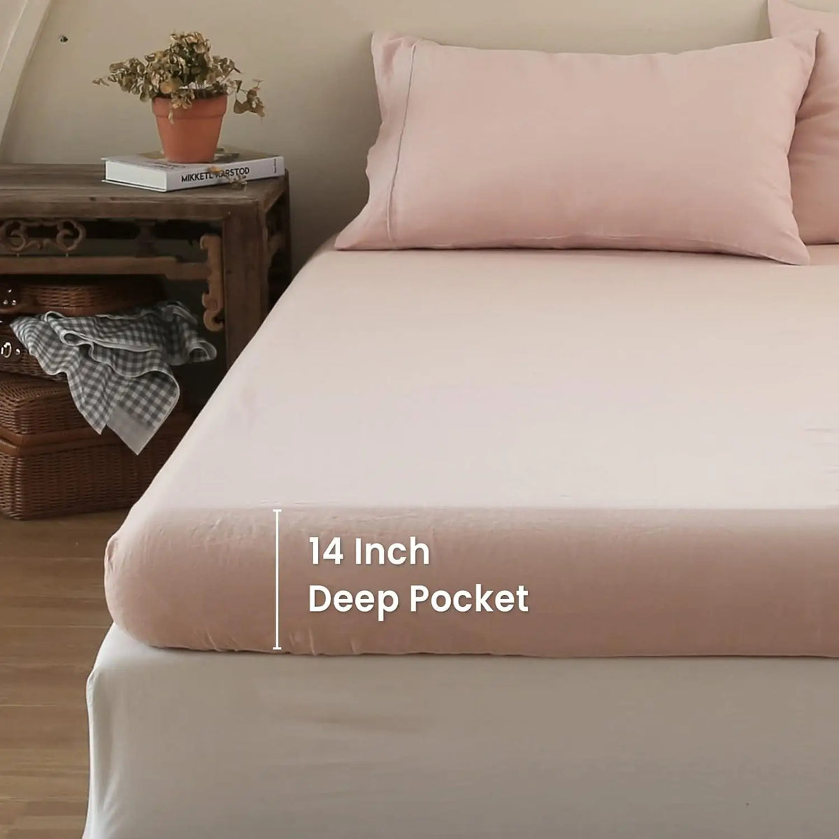A pink linen fitted sheet with a 14 inch deep pocket is displayed on a bed.