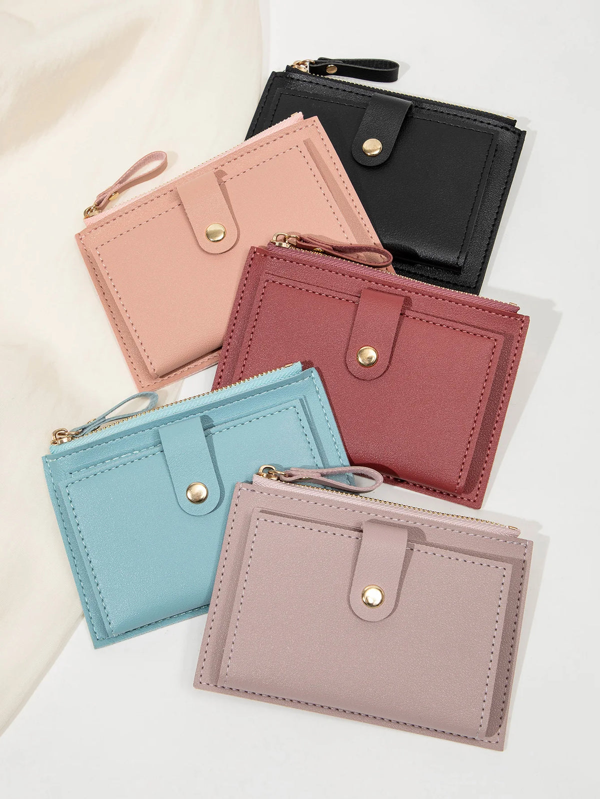 A collection of five women's slim PU leather card holder wallets in shades of pink, mauve, and black.