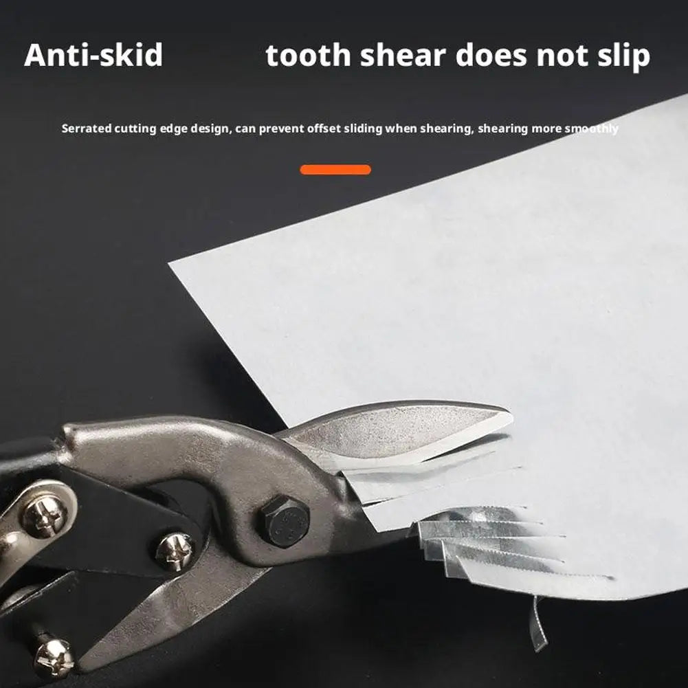 Close-up of heavy-duty aviation snips cutting a sheet of white paper.