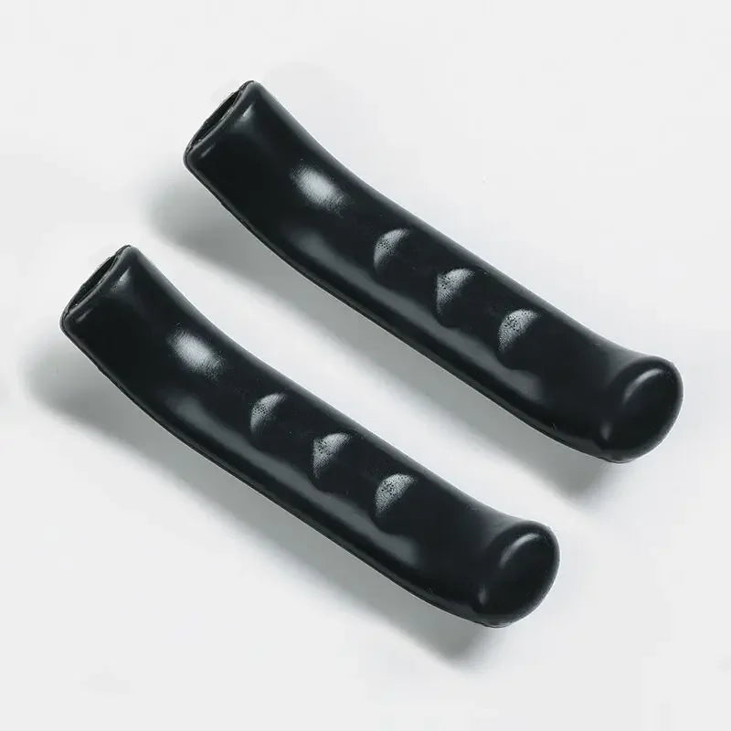 A pair of black silicone bicycle brake lever covers shown diagonally on a white background.