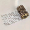 A roll of thin, wire-like netting with a hexagonal mesh pattern laid out next to the coiled material.
