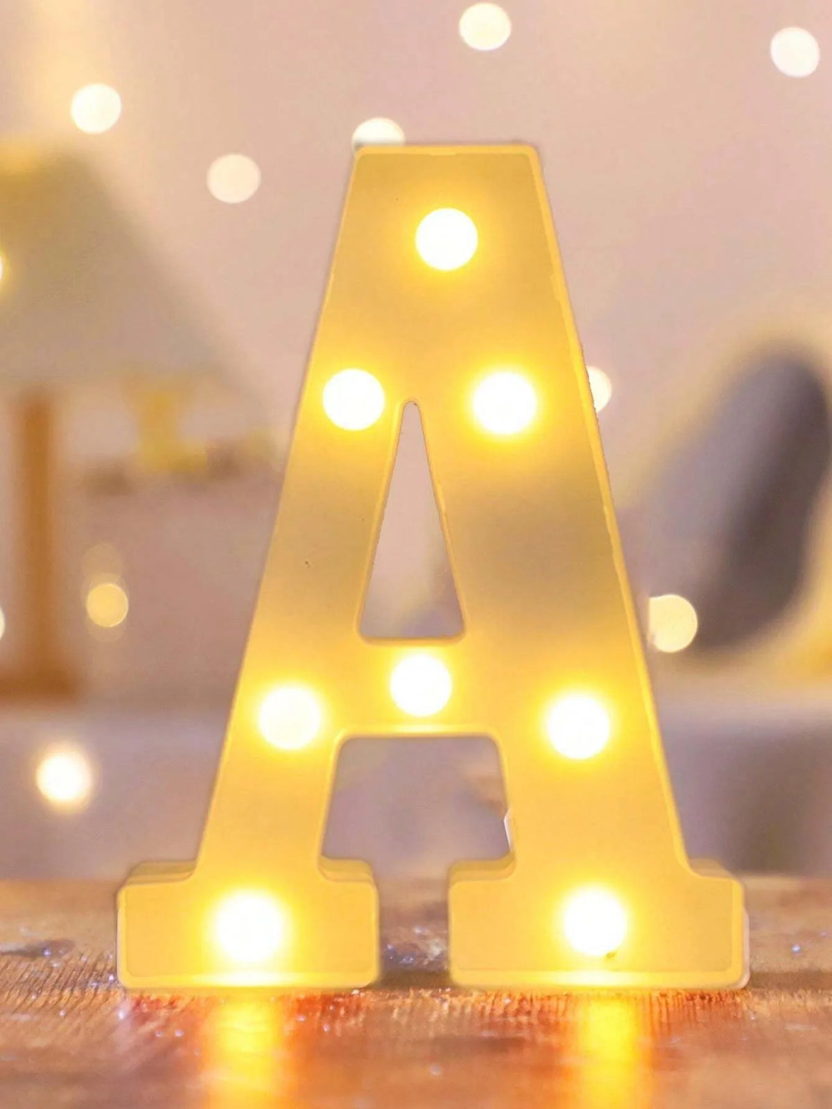 A letter night light shaped like the letter A made of glowing yellow LED lights