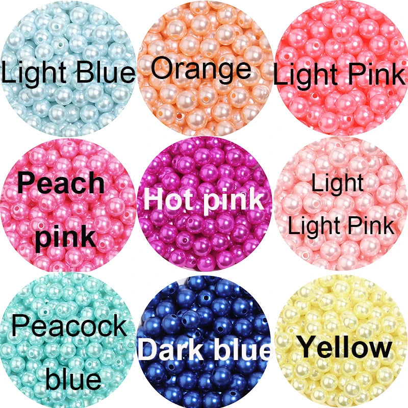 A collection of round imitation pearl beads in various colors including light blue, orange, pink, peach, hot pink, dark blue,