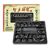 A black metal wire puzzle brain teaser set with various coiled and straight wires displayed next to a vintage-style box.