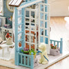 A DIY miniature dollhouse kit featuring a wooden puzzle craft with LED lights and decorative elements.