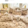 A beige duvet cover set featuring a repeating pattern of small brown dogs on a light tan background.
