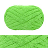 A ball of bright lime green chunky chenille yarn for hand knitting and crochet
