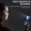 A close-up of a woman's face with a grid overlay, looking at an iPhone screen in a dark environment.