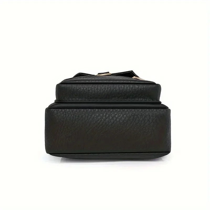 A black PU leather crossbody bag with a gold-toned strap shown from the top view.