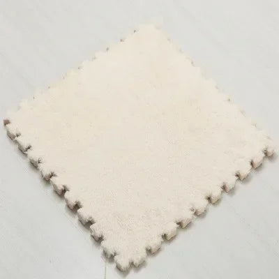 A square mat of soft, cream-colored plush interlocking floor tiles.