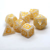 A collection of yellow translucent polyhedral dice with gold dragon embellishments