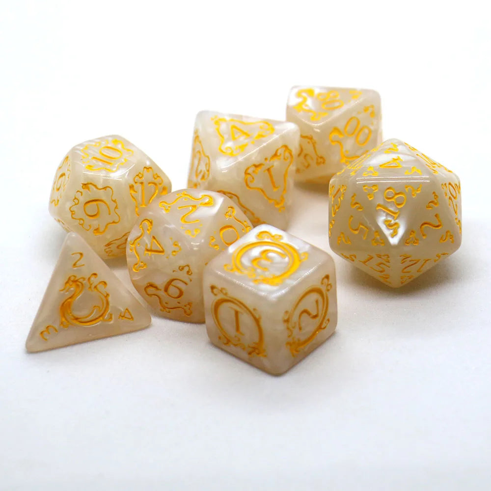 A collection of yellow translucent polyhedral dice with gold dragon embellishments