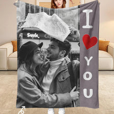 A custom photo flannel blanket featuring a couple smiling while holding a map.