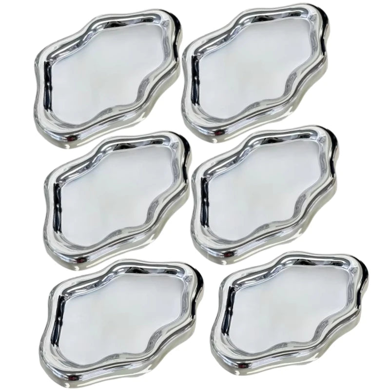 A set of five cloud-shaped silver jewelry trays.