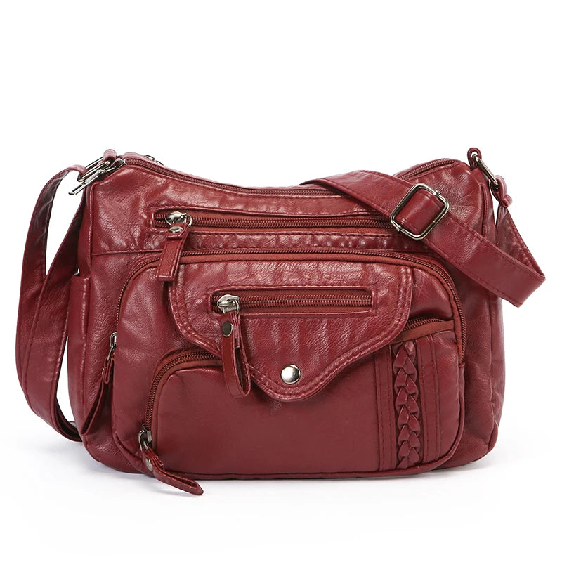 A maroon leather tote bag with a flap closure and adjustable strap is shown against a white background.
