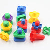 A collection of colorful screw and nut building blocks in various shades of green, yellow, blue, purple, and red.
