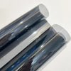 Close-up view of a roll of ceramic car window tint film showing various shades of blue and gray.