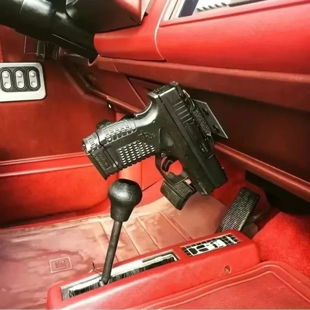A black magnetic gun mount with a quick-release lock is shown installed in the interior of a red car.