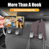 Car seat headrest hooks used to organize bags and items in a vehicle interior.