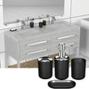 A set of four black bathroom accessories including a soap dispenser, holder, and dish on a marble vanity top.