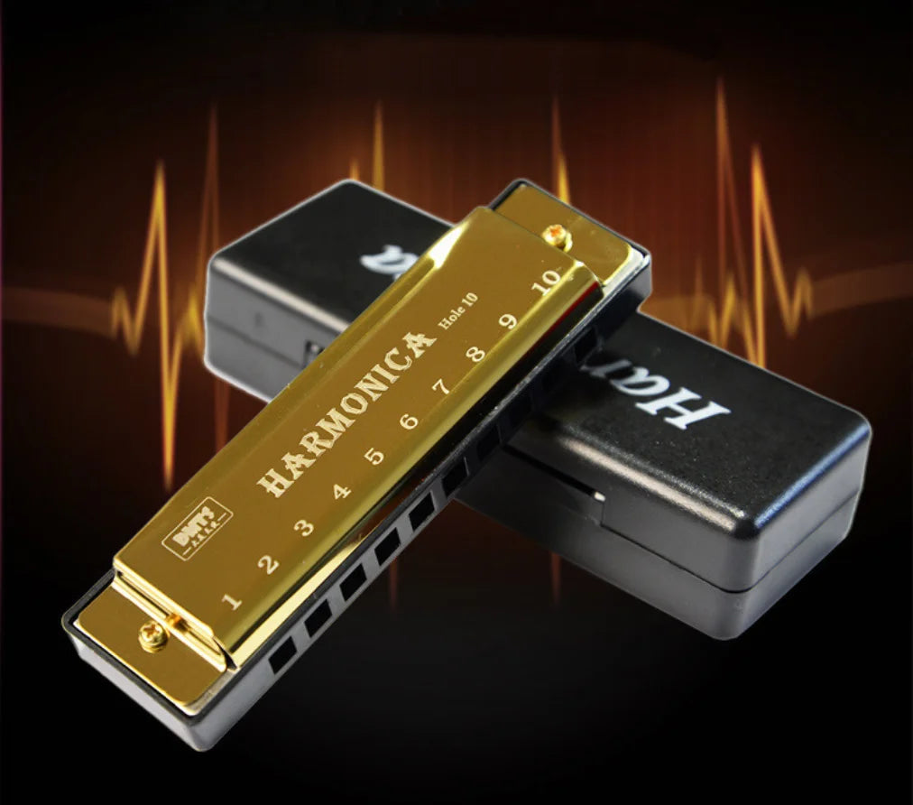 A gold-colored harmonica with 10 holes is shown alongside its protective case against a dark background.
