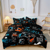 A black gamer-themed duvet cover set featuring a print of a controller and keyboard on a bed.