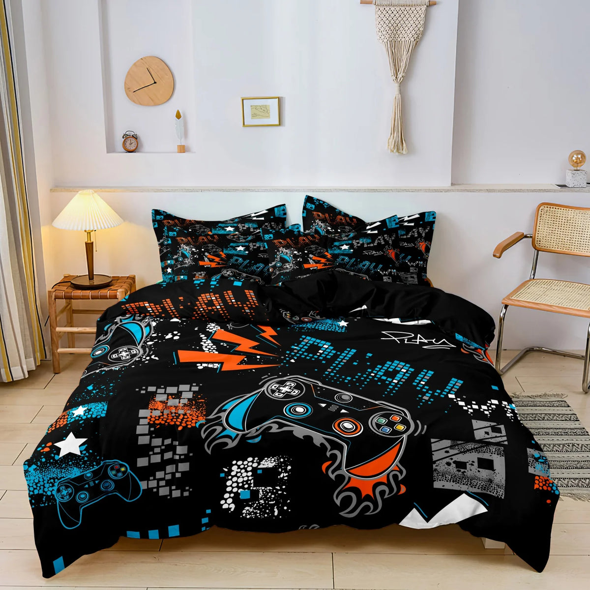 A black gamer-themed duvet cover set featuring a print of a controller and keyboard on a bed.
