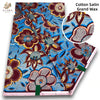 Cotton Satin Grand Wax fabric featuring a vibrant blue and brown floral print with pink glitter accents