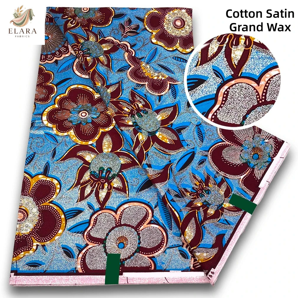 Cotton Satin Grand Wax fabric featuring a vibrant blue and brown floral print with pink glitter accents